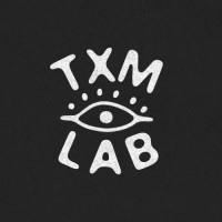 TXM LAB logo - Similar company to Us Vs Them